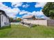 Large backyard with a pool, white privacy fence, and an open, green lawn, ideal for outdoor gatherings at 12104 Shallot St, Orlando, FL 32837