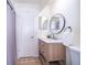 Well-lit bathroom featuring modern vanity, round mirror, and a stylish tile floor, designed for comfort and sophistication at 12104 Shallot St, Orlando, FL 32837