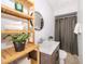 Cozy bathroom features modern vanity, round mirror, and neatly folded towels on shelf at 12104 Shallot St, Orlando, FL 32837