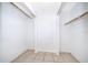 Walk-in closet featuring white walls, tile floor, and a hanging rod, perfect for organizing clothes and accessories at 12104 Shallot St, Orlando, FL 32837