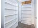 This closet features bright white built-in shelves for storage and organization at 12104 Shallot St, Orlando, FL 32837