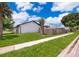 Side view of a home with a lush green lawn and walkway, blending curb appeal with a comfortable neighborhood setting at 12104 Shallot St, Orlando, FL 32837
