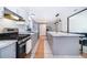 Bright kitchen features stainless steel appliances, spacious island, and gray cabinets at 12104 Shallot St, Orlando, FL 32837