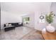 Bright living room with light tile floors, a sleek gray-tone sofa, and a decorative front door at 12104 Shallot St, Orlando, FL 32837