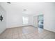 Open living room with tile floors, sliding glass door, and window provides plenty of light at 12104 Shallot St, Orlando, FL 32837