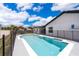 Backyard pool with gray tile and an attached covered patio, perfect for outdoor relaxation at 12104 Shallot St, Orlando, FL 32837