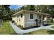 Side view of a bright home featuring manicured landscaping, a small porch and freshly painted exterior at 1602 W 12Th St, Sanford, FL 32771