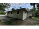 Side view of the home featuring a well-maintained exterior and a spacious driveway at 1602 W 12Th St, Sanford, FL 32771
