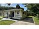 Exterior view of a cozy home with fresh landscaping and a well-maintained lawn at 1602 W 12Th St, Sanford, FL 32771