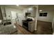 Modern kitchen features new cabinets, granite countertops, stainless steel appliances, and wood-look floors at 1602 W 12Th St, Sanford, FL 32771