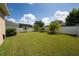 Expansive backyard featuring a well-manicured lawn, privacy fence, and mature landscaping, perfect for outdoor enjoyment at 1703 Leatherback Ln, St Cloud, FL 34771