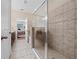 Bathroom boasts a glass-enclosed shower, tile flooring, and neutral color palette at 1703 Leatherback Ln, St Cloud, FL 34771