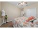This bedroom features laminate flooring, a ceiling fan, and tasteful decor at 1703 Leatherback Ln, St Cloud, FL 34771