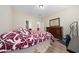 This bedroom features a spacious layout, a large bed with patterned bedding, and dark wood dresser at 1703 Leatherback Ln, St Cloud, FL 34771