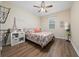 Bedroom boasts laminate flooring, a ceiling fan, ample lighting, and unique decorations at 1703 Leatherback Ln, St Cloud, FL 34771