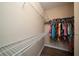 Walk in closet features shelving on both sides and laminate flooring at 1703 Leatherback Ln, St Cloud, FL 34771