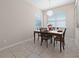 Bright dining room features tile flooring, a modern light fixture, and large windows offering natural light at 1703 Leatherback Ln, St Cloud, FL 34771