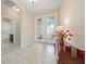 Elegant foyer with tile flooring, glass double doors, and stylish decor at 1703 Leatherback Ln, St Cloud, FL 34771