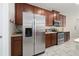 Contemporary kitchen with stainless steel appliances, tile backsplash, and ample counter space at 1703 Leatherback Ln, St Cloud, FL 34771