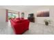 Comfortable living room with tile flooring, large windows, and a cozy atmosphere at 1703 Leatherback Ln, St Cloud, FL 34771