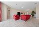 Inviting living room featuring tile floors, ample seating, and bright, neutral decor at 1703 Leatherback Ln, St Cloud, FL 34771