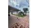A brick paved backyard with a covered patio, some plants, and some gardening at 2013 Marilyn Ave, Winter Haven, FL 33881