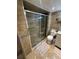 This bathroom features a glass shower, tiled floors, a toilet, and a sink at 2013 Marilyn Ave, Winter Haven, FL 33881