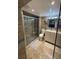 Bathroom with a glass shower, sink and cabinets, tiled floors, and a toilet at 2013 Marilyn Ave, Winter Haven, FL 33881