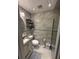 Bathroom boasts tiled walls, a toilet, and a sink with vanity cabinet, offering practical design at 2013 Marilyn Ave, Winter Haven, FL 33881