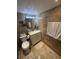 This bathroom features a sink and cabinets, tiled floors, a shower, and a toilet at 2013 Marilyn Ave, Winter Haven, FL 33881