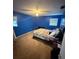 Cozy bedroom featuring a ceiling fan, neutral carpet, and natural lighting from the two windows at 2013 Marilyn Ave, Winter Haven, FL 33881
