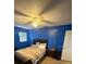 Cozy bedroom featuring a ceiling fan, neutral carpet, and natural lighting from the two windows at 2013 Marilyn Ave, Winter Haven, FL 33881