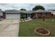 Charming single-story brick home with a well-manicured lawn and a two-car garage at 2013 Marilyn Ave, Winter Haven, FL 33881