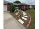 Inviting walkway leading to a screened front porch and a charming brick home at 2013 Marilyn Ave, Winter Haven, FL 33881