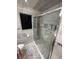 Bright bathroom features a glass-enclosed shower with marble tile walls and modern fixtures at 2013 Marilyn Ave, Winter Haven, FL 33881