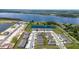 Aerial view showcasing a planned community with homes, a lake and green spaces with neighborhood streets at 2211 Tay Wes Dr, St Cloud, FL 34771