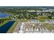 Aerial view showcasing residential home in a planned community near a lake and wooded areas at 2211 Tay Wes Dr, St Cloud, FL 34771
