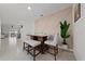 Stylish dining area featuring a modern accent wall and seating for four, adjacent to the living spaces at 2211 Tay Wes Dr, St Cloud, FL 34771