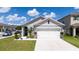 Charming single-Gathering home with a well-maintained lawn, attached two-car garage and neutral color palette at 2211 Tay Wes Dr, St Cloud, FL 34771