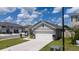 Charming home exterior featuring a well-manicured lawn and a two-car garage at 2211 Tay Wes Dr, St Cloud, FL 34771