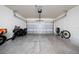 Spacious two-car garage with ample room for vehicles and storage, including a motorcycle at 2211 Tay Wes Dr, St Cloud, FL 34771