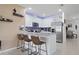Modern kitchen with stainless steel appliances, granite countertops, breakfast bar with stools, and white cabinets at 2211 Tay Wes Dr, St Cloud, FL 34771