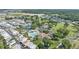 An aerial view of the community showcasing tennis courts, shuffleboard courts, community pool, golf course, and a clubhouse at 2343 St George Dr, Davenport, FL 33837