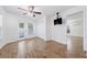Bright bedroom with wood-look floors, a ceiling fan, natural light, and closet space, for a warm and inviting atmosphere at 2343 St George Dr, Davenport, FL 33837