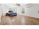 Bright bedroom features wood-look tile flooring, ceiling fan, and modern mini-split air conditioning at 2343 St George Dr, Davenport, FL 33837
