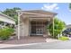 Beautiful covered entrance and outdoor living space with neutral siding and brick paved driveway, creating great curb appeal at 2343 St George Dr, Davenport, FL 33837