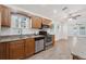 Kitchen with wood cabinets, granite counters and stainless appliances and an easy flow to the living spaces at 2343 St George Dr, Davenport, FL 33837