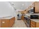 Spacious kitchen with wood cabinets, granite counters, stainless steel appliances, and wood-look flooring at 2343 St George Dr, Davenport, FL 33837