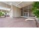 Spacious, covered, screened outdoor living space featuring a brick floor and outdoor ceiling fans for a relaxing atmosphere at 2343 St George Dr, Davenport, FL 33837