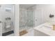 Modern bathroom featuring marble floors, double sinks, and a glass-enclosed shower at 2668 Coachman Dr, Deltona, FL 32738